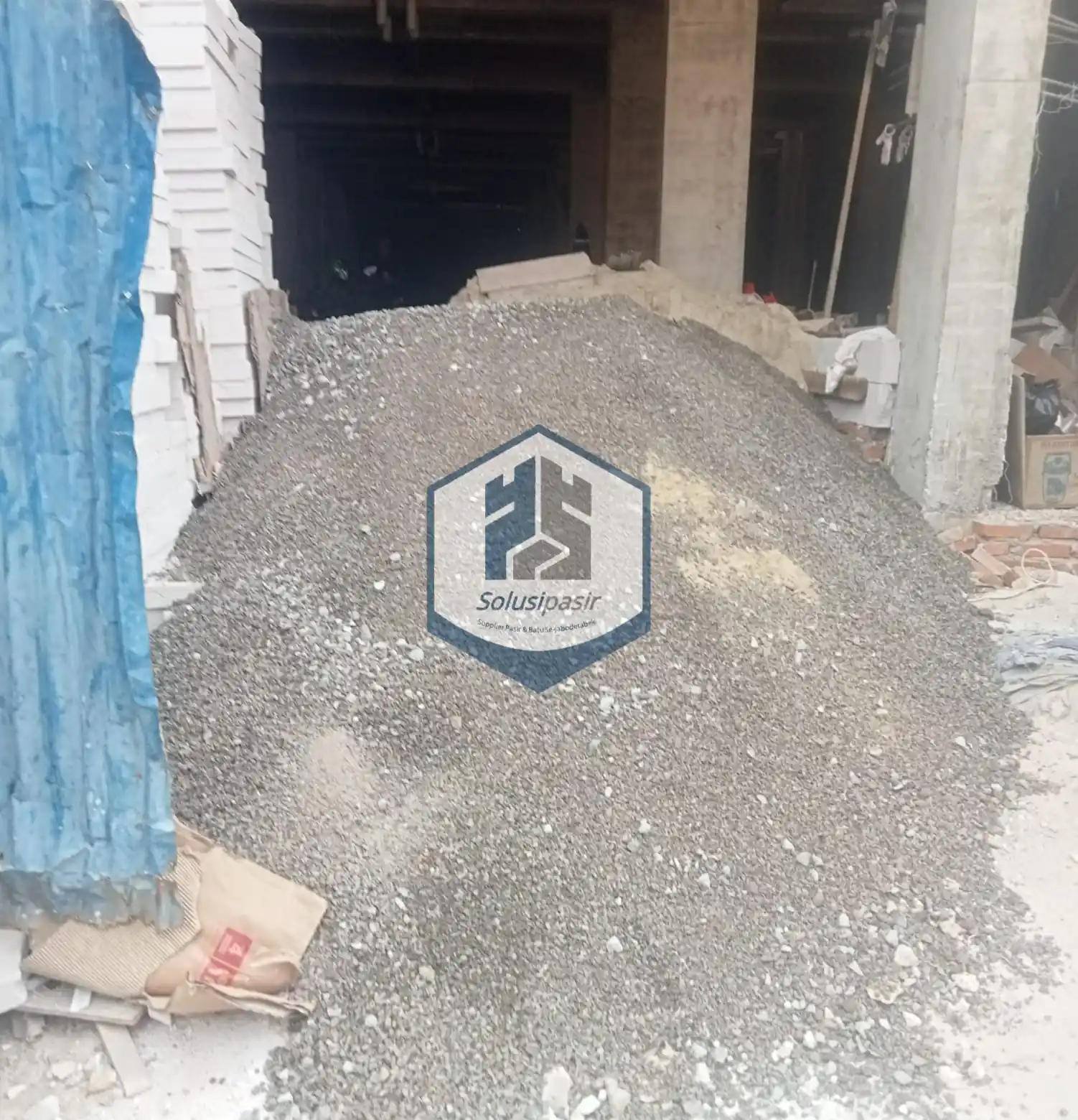 Truk logistik sedang melakukan bongkar muat batu screening di Depok